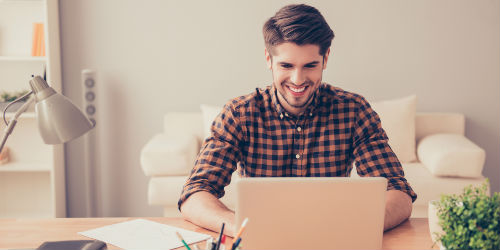 man sitting in front of the computer smiling